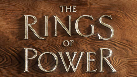 4K Ultra HD PC desktop wallpaper featuring the title design of the TV show The Lord of the Rings: The Rings of Power on a textured wooden background.