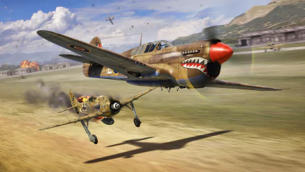 Military HD PC desktop wallpaper background: Curtiss P-40 Warhawk with shark-mouth nose skimming a runway, chasing a smaller biplane past hangars and distant hills.