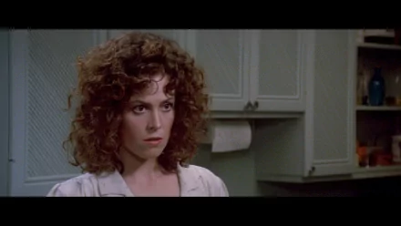 HD PC desktop wallpaper/background: cinematic still from the movie Ghostbusters of a curly‑haired woman in a kitchen, framed in widescreen.