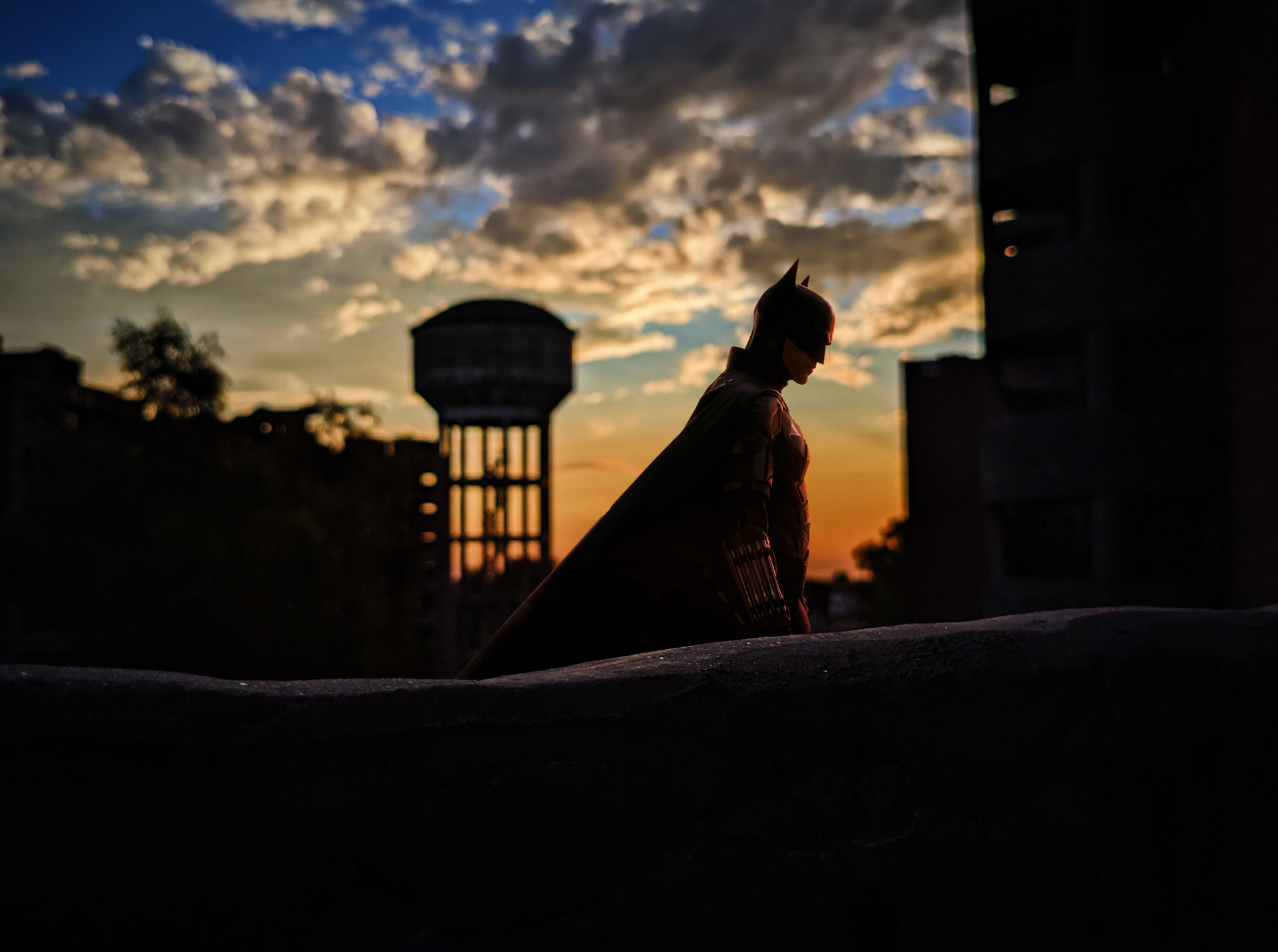Silhouette of The Batman against a dramatic sunset sky, captured in a 4K Ultra HD movie-themed PC desktop wallpaper.