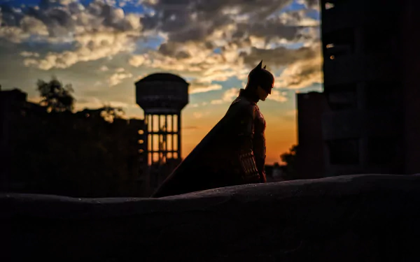 Silhouette of The Batman against a dramatic sunset sky, captured in a 4K Ultra HD movie-themed PC desktop wallpaper.