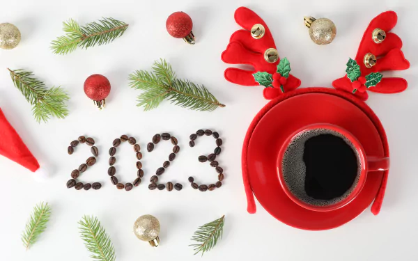 5K Ultra HD PC desktop wallpaper: New Year 2023 holiday scene with a red reindeer coffee mug, '2023' spelled in coffee beans, fir sprigs and red/gold ornaments on white background.