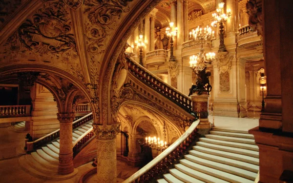 HD wallpaper featuring an opulent, grand staircase inside an ornately decorated building. The intricate architectural details and elegant lighting create a luxurious ambiance.