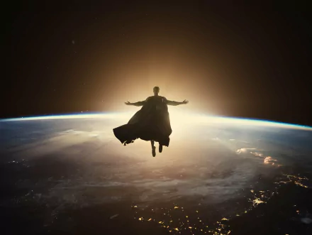 Superman floats above Earth with arms outstretched against a glowing sunrise, a striking HD desktop wallpaper from Zack Snyder's Justice League movie.