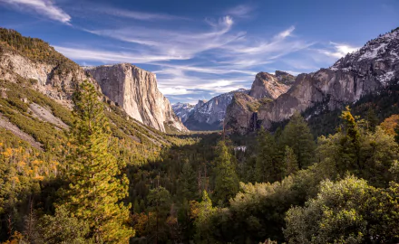 Stunning 8K Ultra HD landscape of Yosemite National Park showcasing towering granite cliffs, lush green forests, and a vibrant sky.