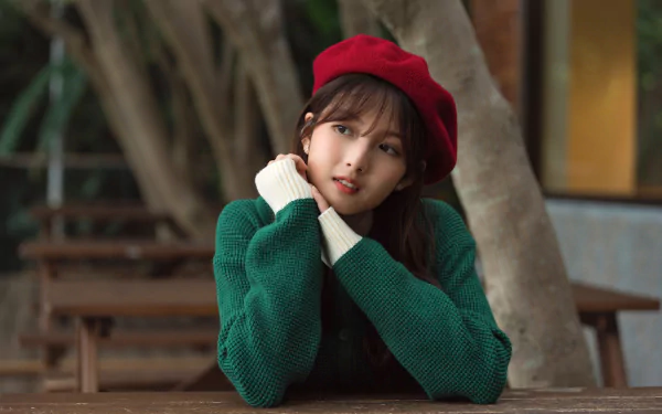 A portrait of an Asian woman wearing a red beret and green sweater, captured in 4K Ultra HD for a PC desktop wallpaper background.
