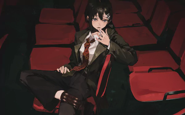Kobeni Higashiyama from Chainsaw Man sits casually in a dimly lit theater, featured in an HD anime desktop wallpaper.