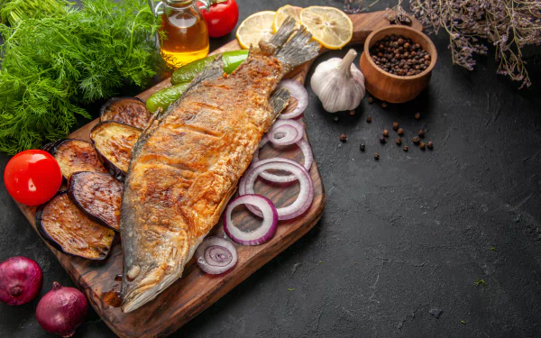 Mouthwatering close-up of a vibrant dish featuring a beautifully grilled fish; a captivating HD wallpaper for desktop background.