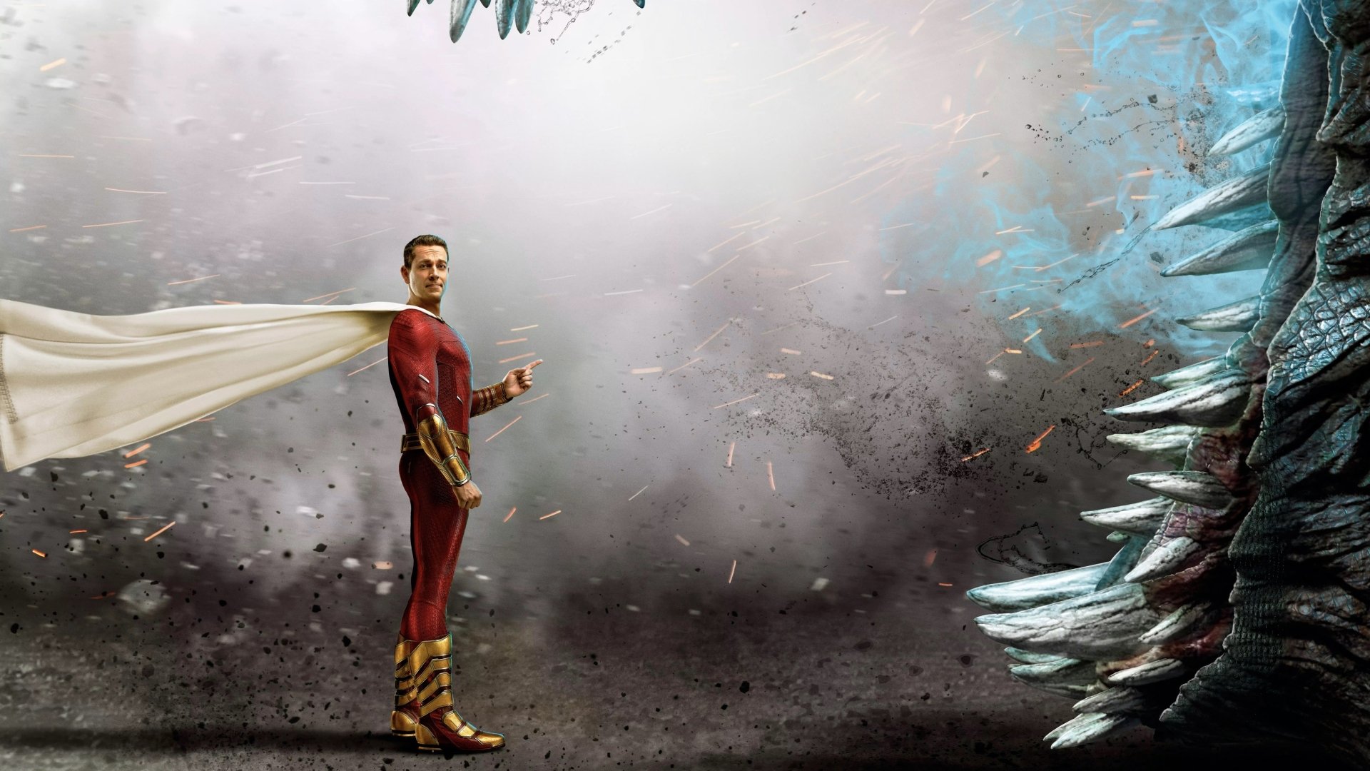 HD PC desktop wallpaper and background from the movie Shazam! Fury of the Gods: Shazam in a red suit with a flowing cape stands in a stormy, debris-filled landscape facing jagged crystalline formations.