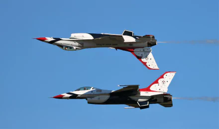 Two United States Air Force Thunderbirds flying General Dynamics F-16 Fighting Falcons in formation against a clear blue sky in this 4K Ultra HD military air show wallpaper.