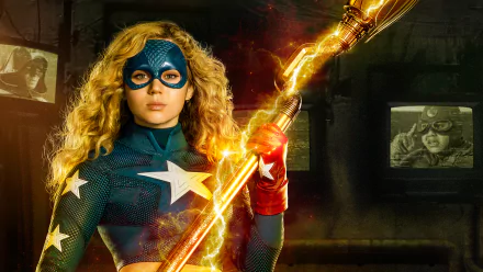 HD PC desktop wallpaper featuring Stargirl from the TV show, holding her glowing cosmic staff against a dark, vintage TV background.