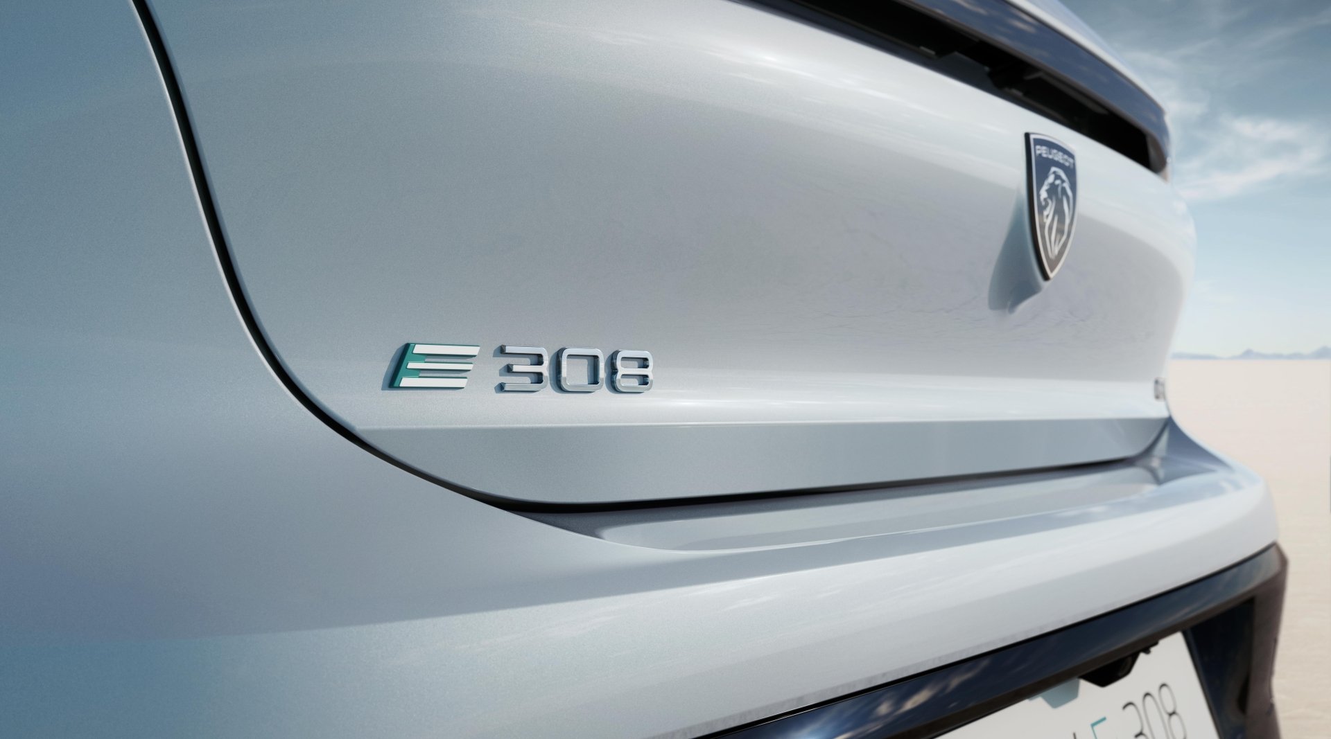 Close-up of the Peugeot e-308 car badge on the rear, highlighting the model name, as a high-definition desktop wallpaper.