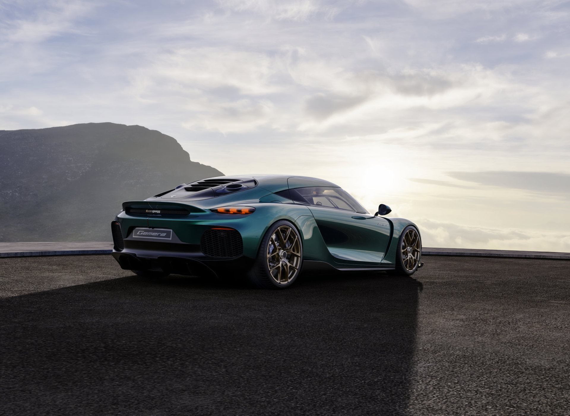 HD desktop wallpaper of a Koenigsegg Gemera parked on a road with a dramatic sky in the background.