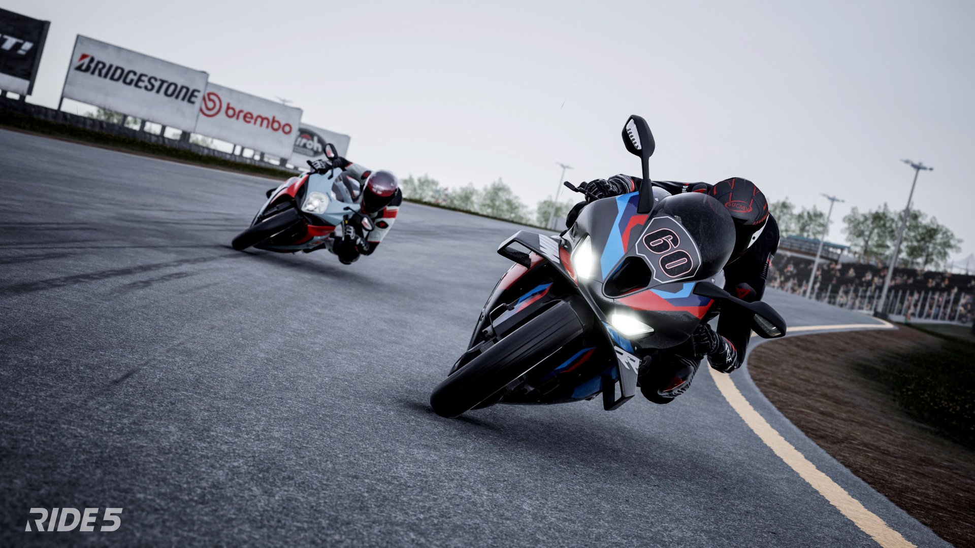 HD desktop wallpaper from the video game Ride 5 showing two motorcycles racing on a track by Bridgestone and Brembo signs.