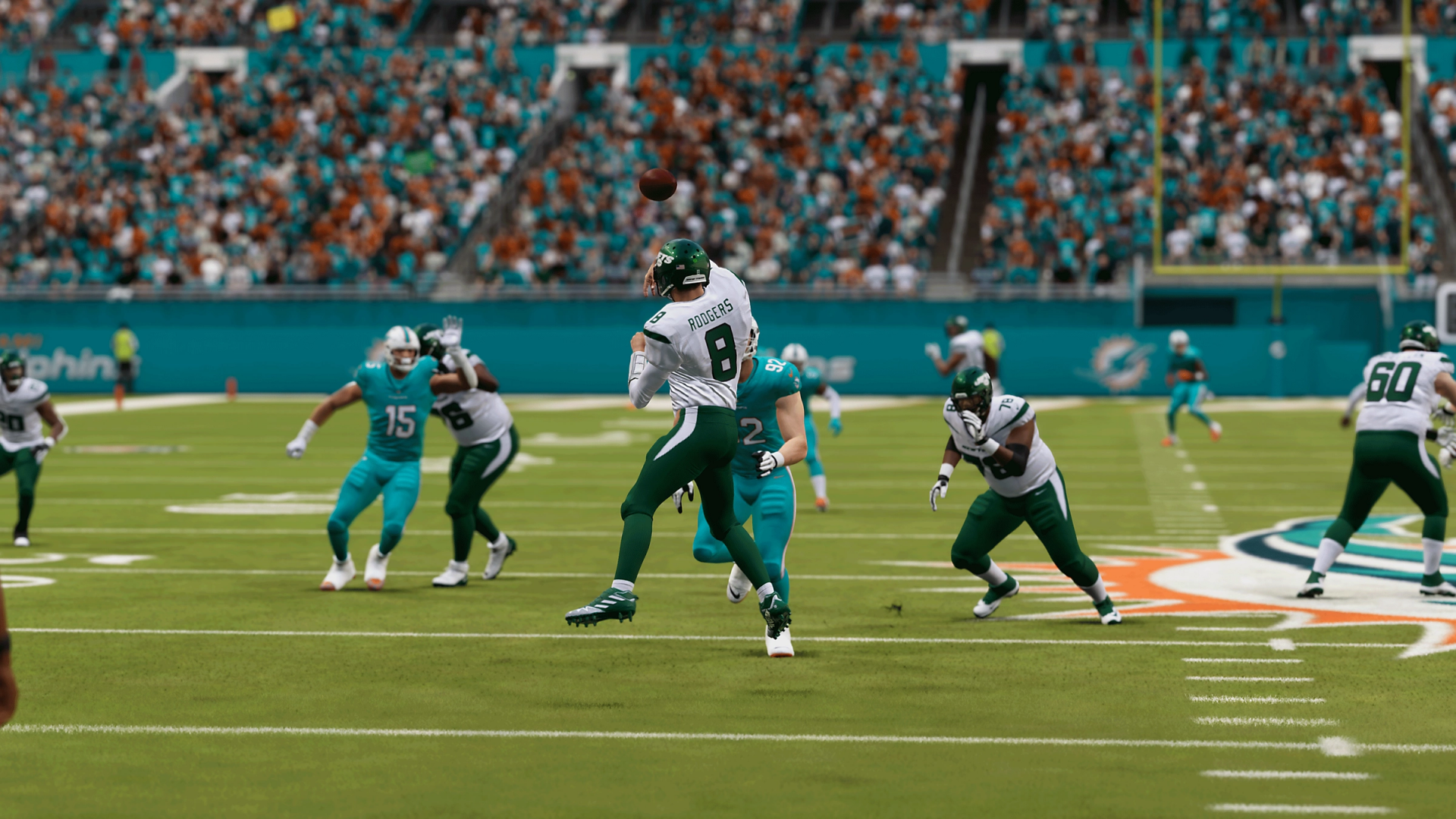 HD desktop wallpaper from Madden NFL 24, featuring a dynamic in-game scene of players on the football field during a play.