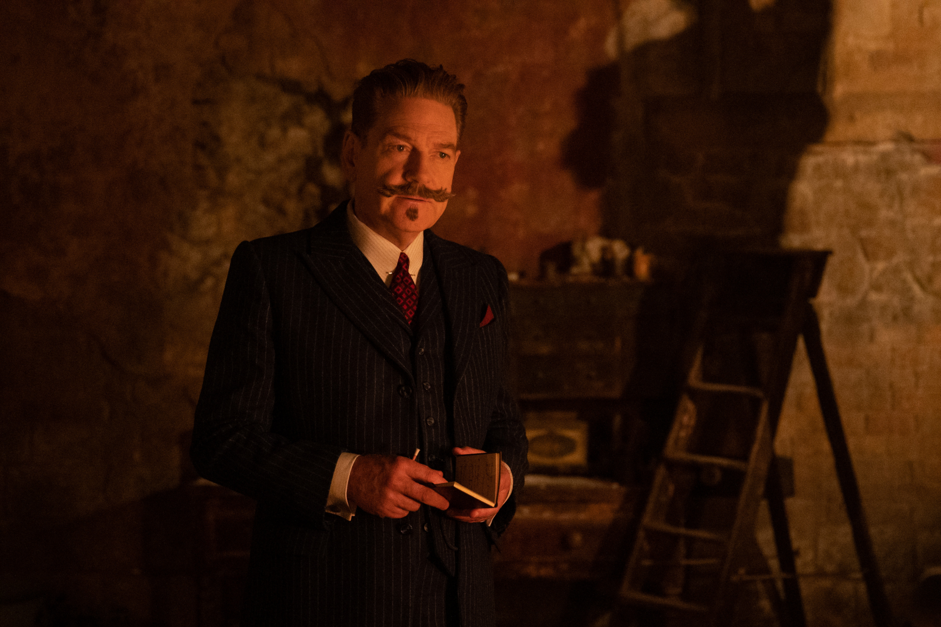 HD desktop wallpaper featuring a man in a pinstripe suit and mustache from A Haunting in Venice for a moody, atmospheric background.