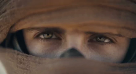 HD desktop wallpaper featuring a close-up of a character's intense eyes from Dune: Part Two.