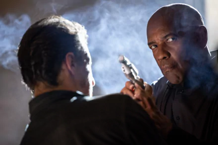 HD desktop wallpaper from The Equalizer 3, featuring a tense confrontation scene with a focused man holding a gun.