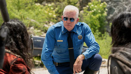 HD wallpaper of Thomas Haden Church in a blue uniform, from the series Twisted Metal, with a pensive expression.