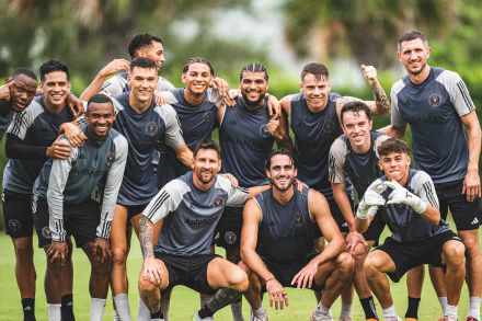 HD desktop wallpaper featuring the Inter Miami CF soccer team smiling and posing together on the field, dressed in team uniforms.