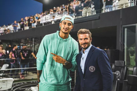 HD desktop wallpaper featuring two well-dressed men, tagged as Kyle Kuzma and David Beckham, posing with a stadium audience in the background.