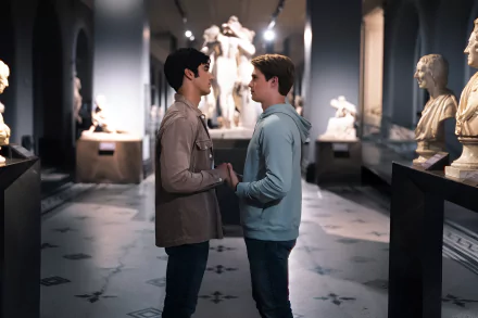 HD wallpaper featuring a heartfelt moment between two characters amidst classical statues, evoking themes from Red, White & Royal Blue.