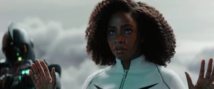 A striking HD wallpaper featuring Teyonah Parris from the movie The Marvels, showcasing her in a dramatic pose against a cloudy backdrop.