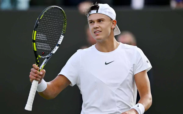 Holger Rune celebrates on the court during Wimbledon 2023, showcasing his dynamic energy and passion for tennis in this vibrant HD desktop wallpaper.