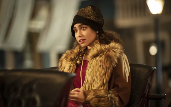 HD wallpaper of Bailey Bass in Interview with the Vampire, dressed in a vintage fur coat and hat.