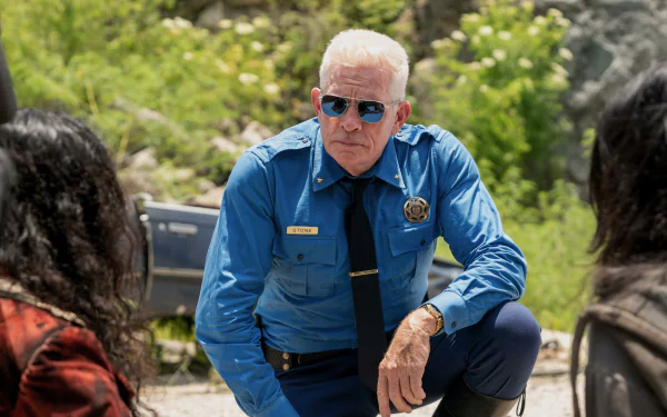 HD wallpaper of Thomas Haden Church in a blue uniform, from the series Twisted Metal, with a pensive expression.