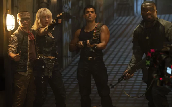 HD wallpaper featuring Expend4bles characters with Jacob Scipio, 50 cent, Tony Jaa, and Levy Tran poised for action in a dimly lit corridor.