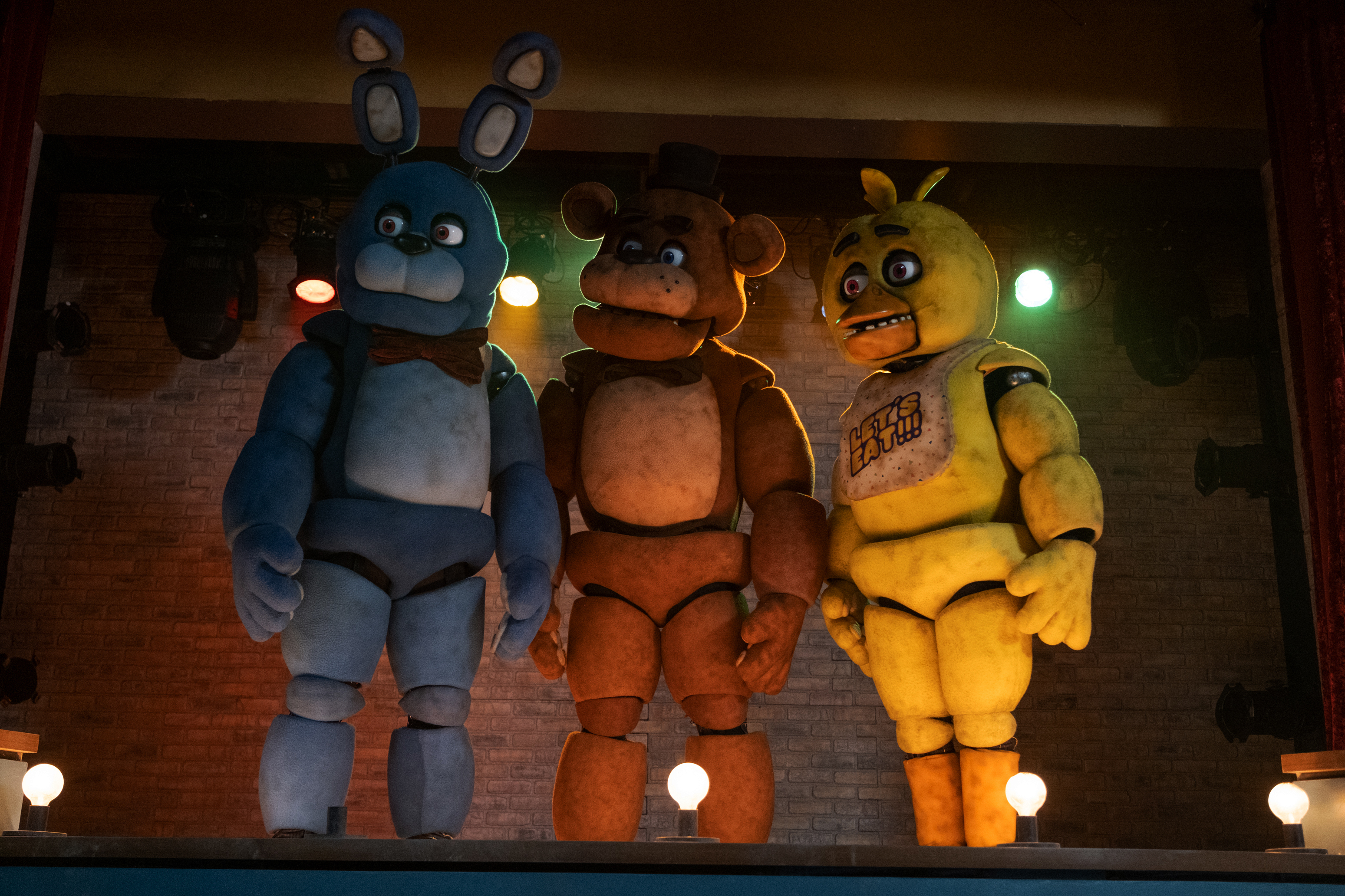 HD wallpaper of Five Nights at Freddy's characters Bonnie, Freddy, and Chica on stage for desktop background.