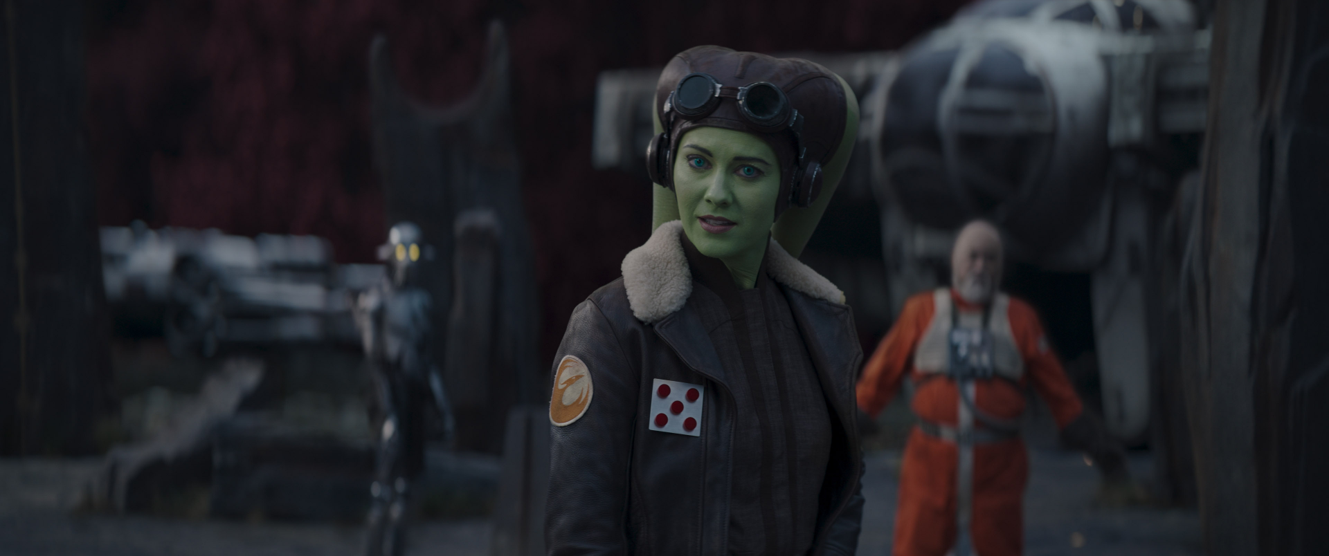 Hera Syndulla from the TV show Ahsoka (2023) stands confidently with her iconic look, set against a dynamic background, making for an engaging HD desktop wallpaper.