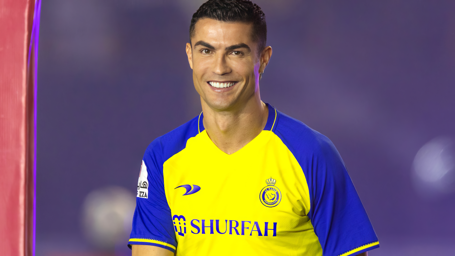 Cristiano Ronaldo smiles in a vibrant yellow and blue sports jersey, capturing his dynamic presence in this HD desktop wallpaper and background.