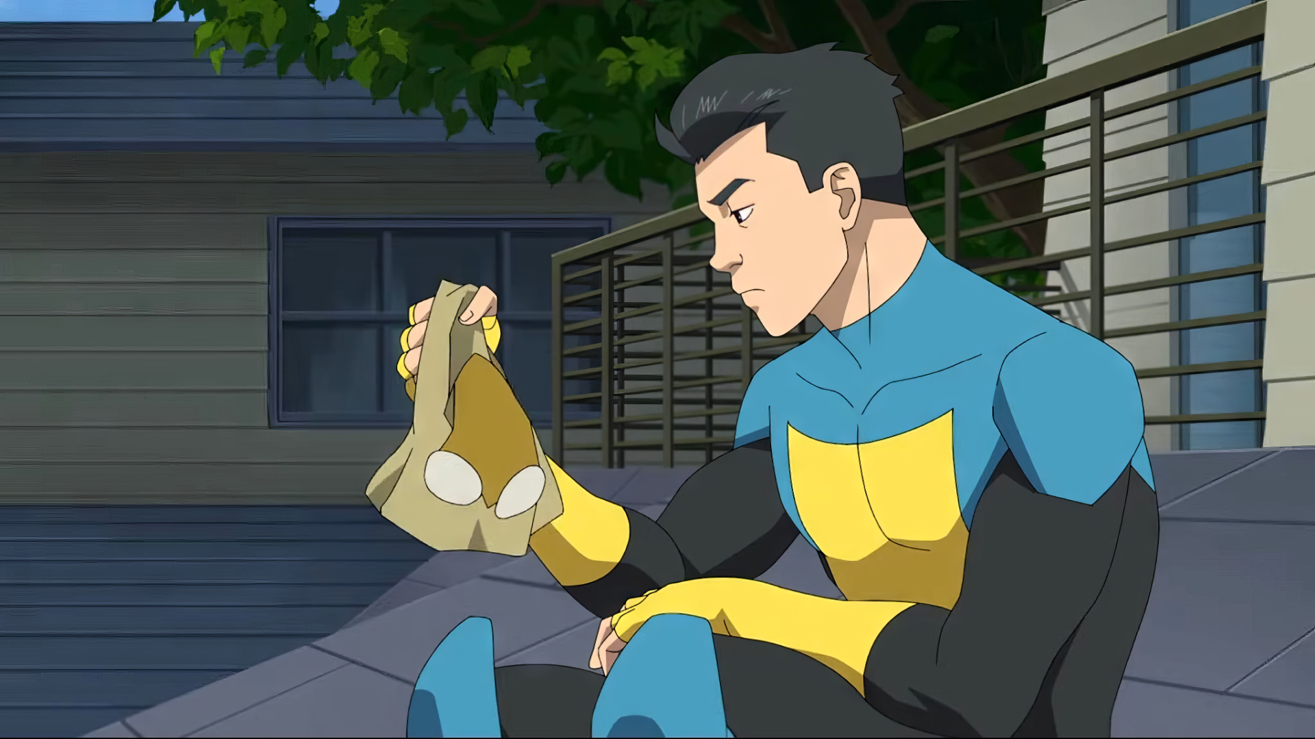 HD wallpaper of Invincible (Mark Grayson) from Image Comics, sitting pensively on steps in costume.