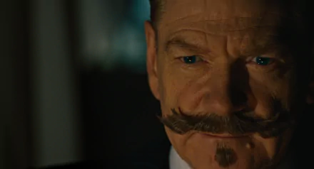 HD wallpaper featuring a close-up of a character from A Haunting in Venice, with a distinctive mustache, expressing intensity.