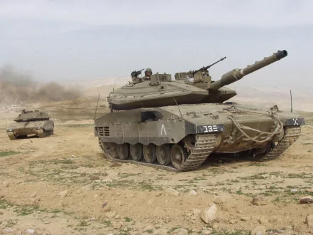 HD PC desktop wallpaper showing military tanks advancing across a dusty desert landscape.