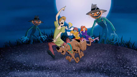 Scene from the TV show What's New, Scooby-Doo? featuring Scooby, Shaggy, Velma, Daphne, and Fred running from pumpkin-headed scarecrows in a 4K Ultra HD PC wallpaper.