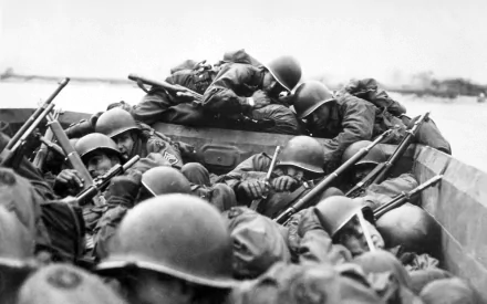 HD desktop wallpaper of soldiers in combat helmets tightly packed in a military landing craft during the historic D-Day invasion.