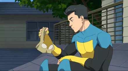HD wallpaper of Invincible (Mark Grayson) from Image Comics, sitting pensively on steps in costume.