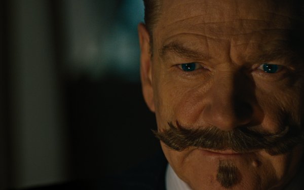 HD wallpaper featuring a close-up of a character from A Haunting in Venice, with a distinctive mustache, expressing intensity.