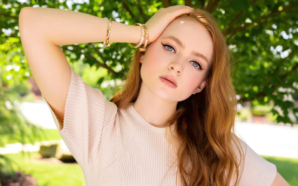 HD desktop wallpaper featuring Sadie Sink in a stylish pose against a neutral background.