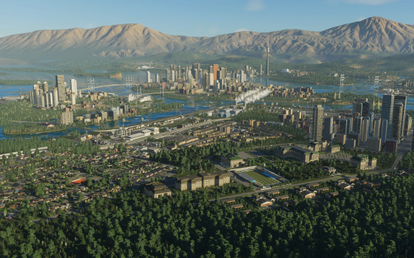 HD wallpaper of Cities: Skylines II showing a detailed and vibrant cityscape with mountains in the background.