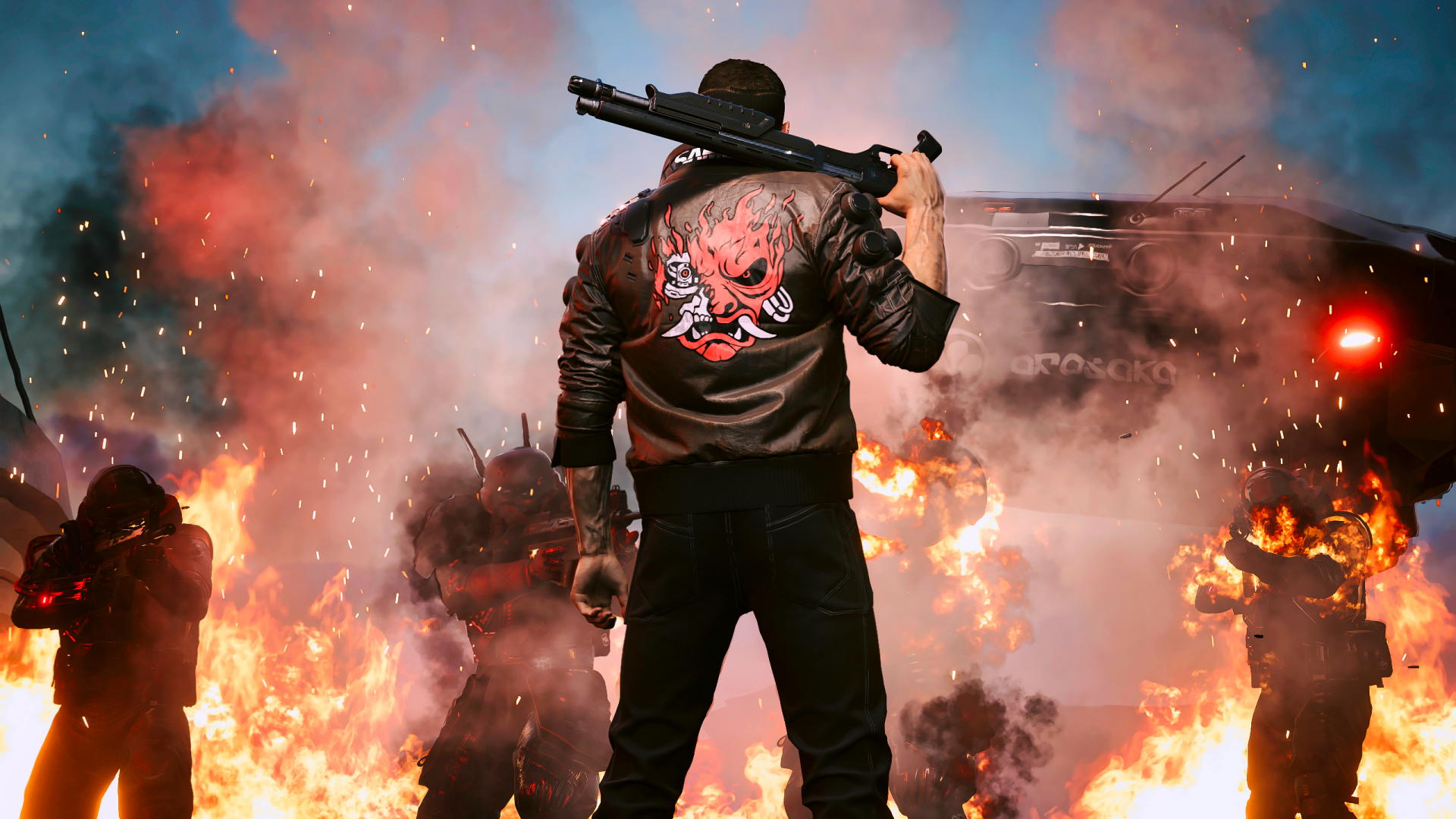 Cyberpunk 2077 video game 2K Quad HD PC desktop wallpaper: jacketed figure with a red crest and bat on his shoulder faces explosions and a burning, neon-lit cityscape.