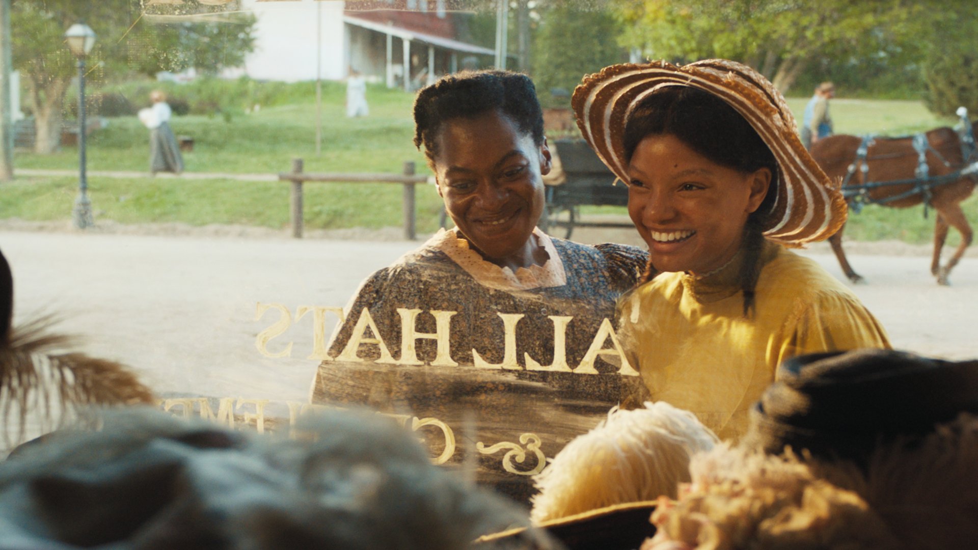 HD wallpaper featuring a joyful scene from the 2023 movie The Color Purple, with two characters smiling and celebrating.