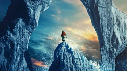 4K Ultra HD PC desktop wallpaper of Aquaman from the movie Aquaman and The Lost Kingdom standing on a rocky peak framed by icy cliffs under a dramatic sky.