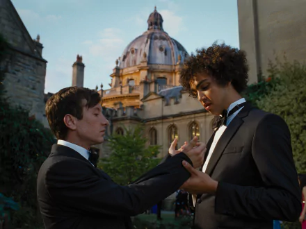 HD desktop wallpaper from the movie Saltburn (2023) featuring two characters in tuxedos, having an intense conversation.