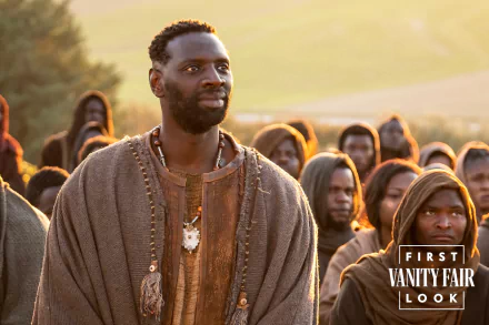 HD wallpaper of a scene from the movie 'The Book of Clarence' with a focused man in the foreground and a group of people in the background, as part of Vanity Fair's first look.