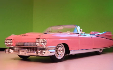 HD desktop wallpaper featuring a classic pink Cadillac convertible against a green background.