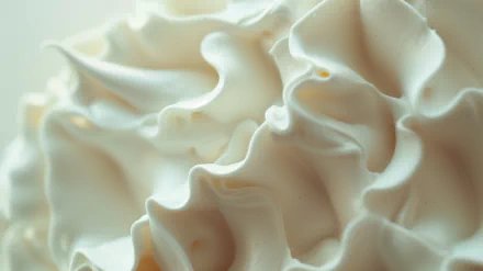 HD desktop wallpaper featuring a close-up view of fluffy whipped cream with soft peaks and a creamy texture.